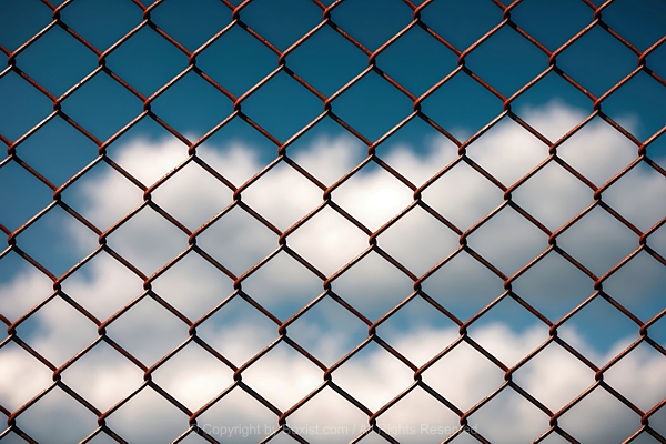 Chain Link Fence With Blue Sky Background