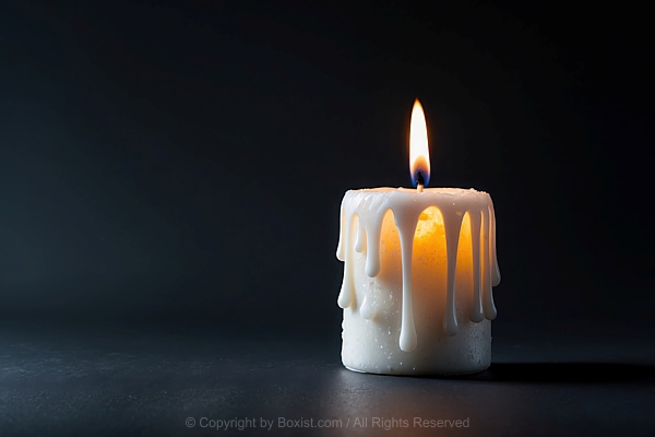 Single White Candle With Flickering Flame Against Black Background