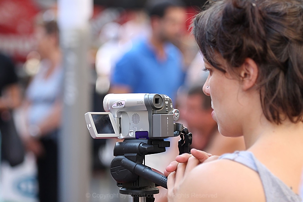 Woman Filming With Camera