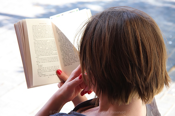 Woman Reading A Book In Hand