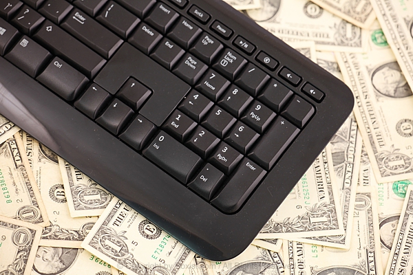 Computer Keyboard On Top Of Dollar Notes