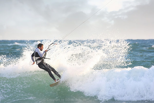 Adventurous Rider Navigating Rough Seas On Surfing Board
