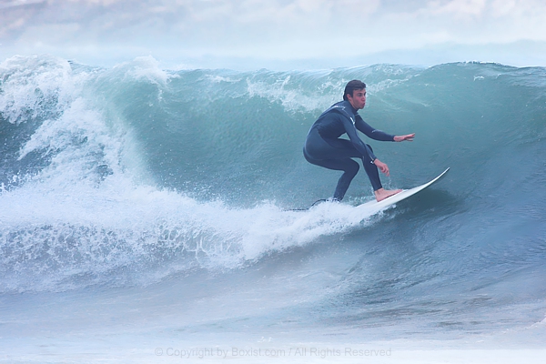 Young Man Surfing The Waves In The Sea