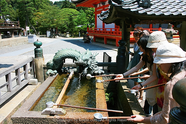 Visitors Using Ladles To Drink From Otowa No Taki Stream At Kiyomizu Dera Temple