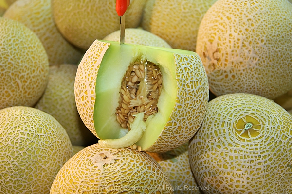 Melons Stacked With One Cut With A Slice Removed