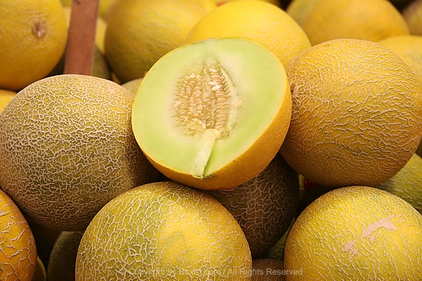 Pile Of Yellow Melons With One Melon Is Cut In Half