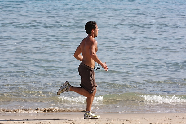 Man Running On The Beach Sand