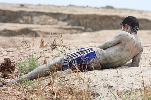 Man Lying With Dead Sea Mineral Mud