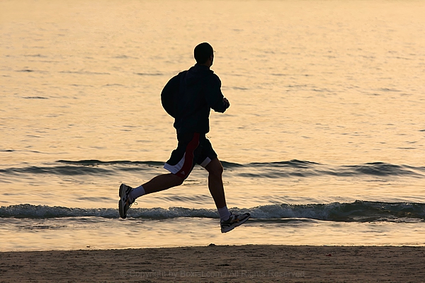 Man Running Fast On The Beach