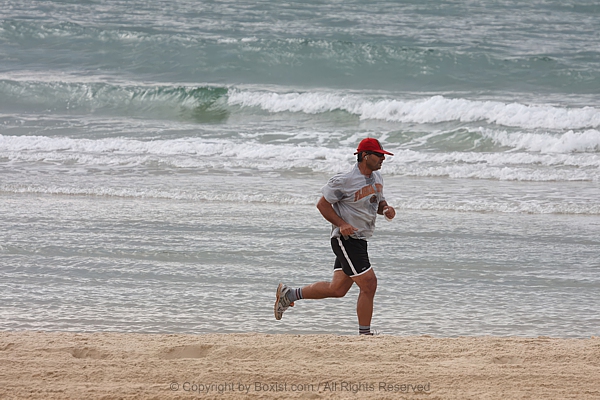Athletic Man Sprinting Along Oceanfront
