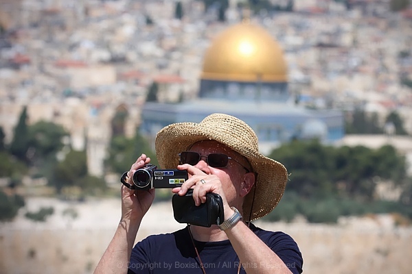 Tourist Capturing Jerusalem Moments With Handheld Camera
