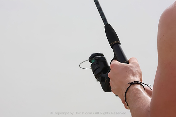 Hands Holding Fishing Rod