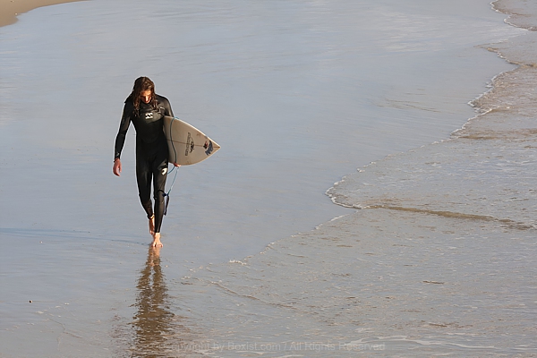 Surfer Walking On The Beach
