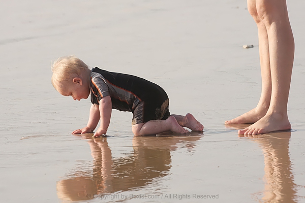 Adorable Little Child Crawling And Playing On Sandy Beach