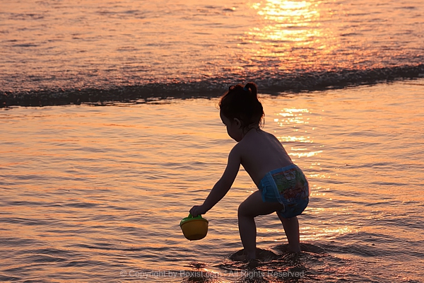 Magical Sunset Moment Girl Silhouette Playing On Wet Shoreline