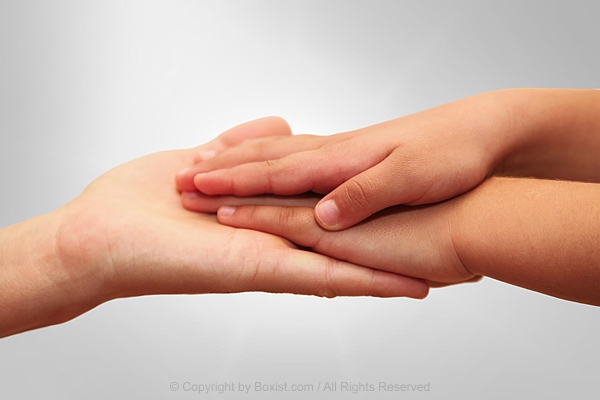 Child Hands Laying On Mother Hand