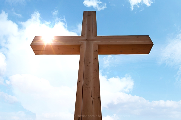 Wooden Cross Against Blue Sky With Clouds
