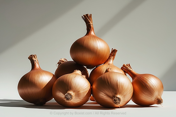 Large Brown Onions Arranged In A Neat Pile On Bright Background