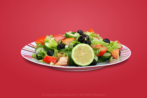 Dish Of Fresh Salad With Half Lemon