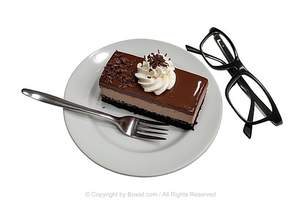 Slice Of Layered Chocolate Cake With Pair Of Black Rimmed Eyeglasses