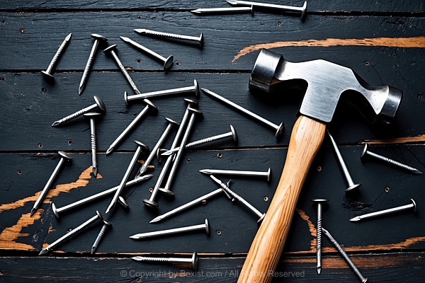 Hammer With Wooden Handle And Metal Head With Scattered Arrangement Of Nails