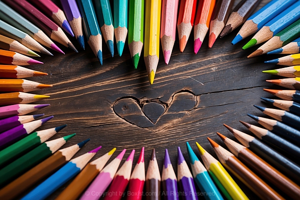 Colored Pencils Arranged In Heart Shape On Wooden Background