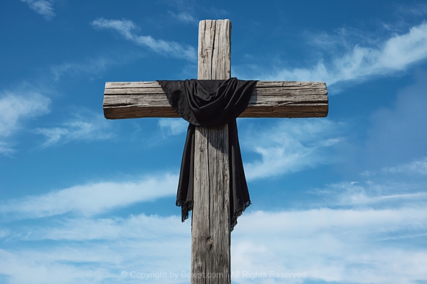 Old Wooden Cross With Draped Black Cloth Against Blue Sky Background