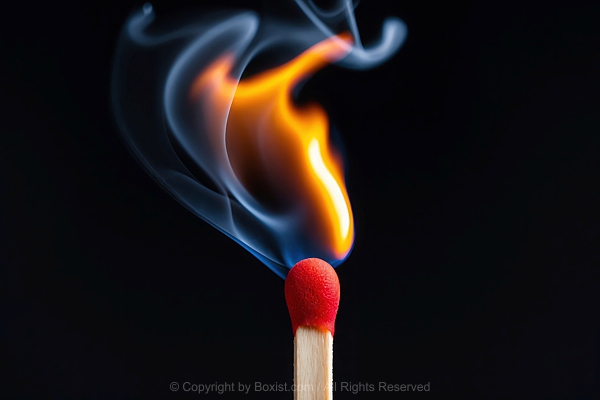 Closeup Of Red Lit Match With Fire And Smoke