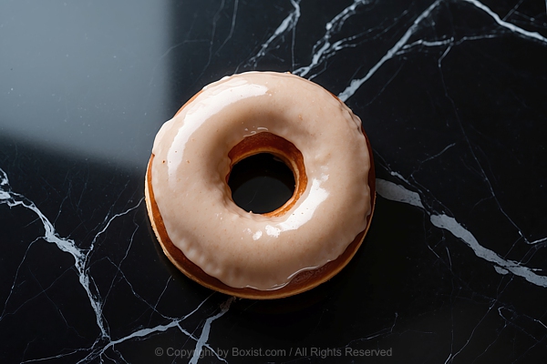 Donuts Resting On Black Marble