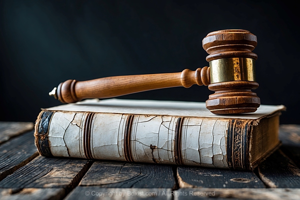 Old Book With Cracked Wooden Judge Gavel On Top