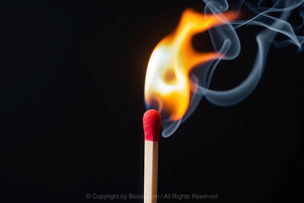Matchstick With Fire And Smoke Against Black Background