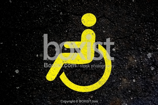 Yellow Handicap Sign Painted on Asphalt