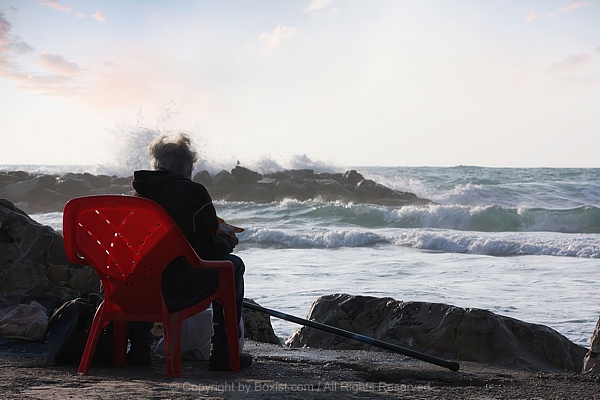 Fisherman Sitting And Watching The Sea